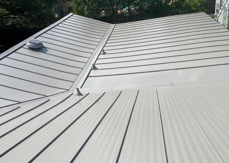 Solar attic fan installed on a metal roof for Roof Ventilation in Biloxi